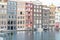 Architecture, gables and window in rows of colorful iconic apartments on Damrak in city