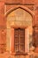 A architecture of gate at humayun tomb memorial from the side of the lawn at winter foggy morning