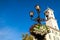 Architecture of Lviv streets on blue sky background. Lamp with flowers.