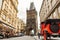 Architecture of Prague old town with red retro car on the street. Gunpowder tower