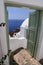 Architecturel building in Santorini with the door open to the ocean. on a sunny sommer holiday.