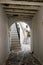 Archway with exposed beams and cobblestone