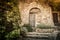 Archway gate and historic stone wall in the garden nook