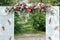 Archway of many beautifil flowers, wedding white arch with peones