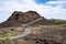 Arco, Idaho - June 30, 2019: Hikers walk up the Spatter Cones trail, a paved walkway leading to a cinder cone wi in Craters of the