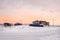 Arctic evening rural landscape. Old disassembled car at the garages in authentic village of Teriberka. Kola Peninsula