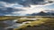 Arctic Landscape: River, Mountain, And Grasses In Icelandic Desert
