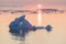 Arctic nature landscape with icebergs in Greenland icefjord with midnight sun sunset / sunrise in the horizon.  Early morning