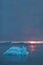 Arctic nature landscape with icebergs in Greenland icefjord with midnight sun sunset / sunrise in the horizon.  Early morning