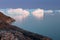 Arctic nature landscape with icebergs in Greenland icefjord with midnight sun sunset / sunrise in the horizon.  Early morning