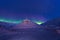 Arctic Northern lights aurora borealis sky star in Norway Svalbard in Longyearbyen city mountains