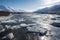 arctic river with ice floes and mountains in the background