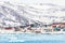 Arctic snow city panorama with colorful Inuit houses on the rock