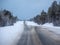 Arctic snow straight winter road through the hills