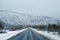 Arctic snow straight winter road through the hills