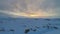 Arctic sunset sky over frozen hill aerial view