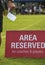 Area reserved banner sign on the sideline of a football pitch in a youth tournamen.