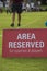 Area reserved banner sign on the sideline of a football pitch in a youth tournamen.