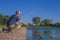 Area trout fishing. Fisherman with spinning rod in action playing fish