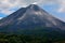 Arenal in Costa Rica. Volcano with exhalation and ash. Beautiful tropic landscape with volcano. Cone active volcano, Central Ameri