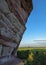 Arenite rock, in Jalapao, Brazil, contrasting with the blue sky and green fields.