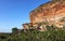 Arenite rock, in Jalapao, Brazil, contrasting with the blue sky and green fields.