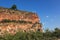 Arenite rock, in Jalapao, Brazil, contrasting with the blue sky and green fields.