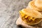 Arepa with shredded beef and cheese on wooden background. Venezuelan typical food