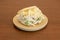 Arepa sifrina with lots of avocado, mayonnaise and grated cheese in a round resin plate
