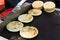 Arepas, Colombian corn patties filled with cheese, at a street food market.