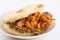 Arepas filled with shredded beef and pork rind served in white dish