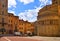 AREZZO,  Cityscape with Piazza Grande square in Arezzo with facade of old historical buildings against cloudy blue sky , Tuscany,