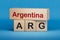 Argentina and ARG symbol. Concept words Argentina and ARG on wooden blocks.