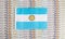 Argentina flag on a background from dollar banknotes. Concept of the relationship of the Argentina money in relation to