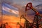 Argentina oil industry concept. Industrial illustration - Argentina flag and oil wells with the red and blue sunset or sunrise sky