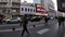 Argentine citizens walking on the sidewalk while vehicles travel on the street