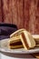 Argentine classic alfajores of cornstarch and dulce de leche with coconut on a vintage plate. Vertical Orientation. Copy text.