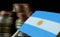 Argentine flag waving with stack of money coins