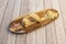 Argentine ham and cheese empanada on wooden board