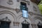 Argentinian flag hangs down vertically from balcony of historic building in Mendoza city