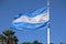 Argentinian flag waving against blue sky