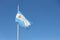 Argentinian flag waving over a blue sky with copy space