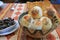 Argentinian Sesame Table Rolls and Breads in a Wooden Basket with Black Beans Dip