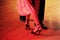 Argentinian tango couple feet in red spotlight