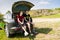 Arguing Couple Sitting on Tailgate of Car by Road