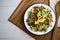 Argula salad with pasta bows, avocado, cherry tomatoes, pomegranate and sesame.