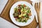 Argula salad with pasta bows, avocado, cherry tomatoes, pomegranate and sesame.