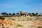 Arid barren land in ibiza on which stands a typical square house