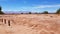 The arid and desolate landscape of the Atacama Desert and the peaks of the snowy volcanoes of the Andes cordillera in the backgrou