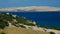 Arid foliage, rocks, settlements and appartments on shoreline of Pag island, Croatia, near Sv. Marko and beach Sv. Maria